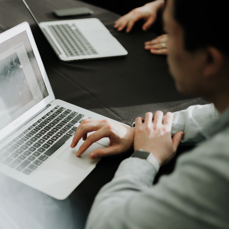 Person working on a laptop at a desk